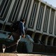 A man walks past Langson Library, at UC Irvine.