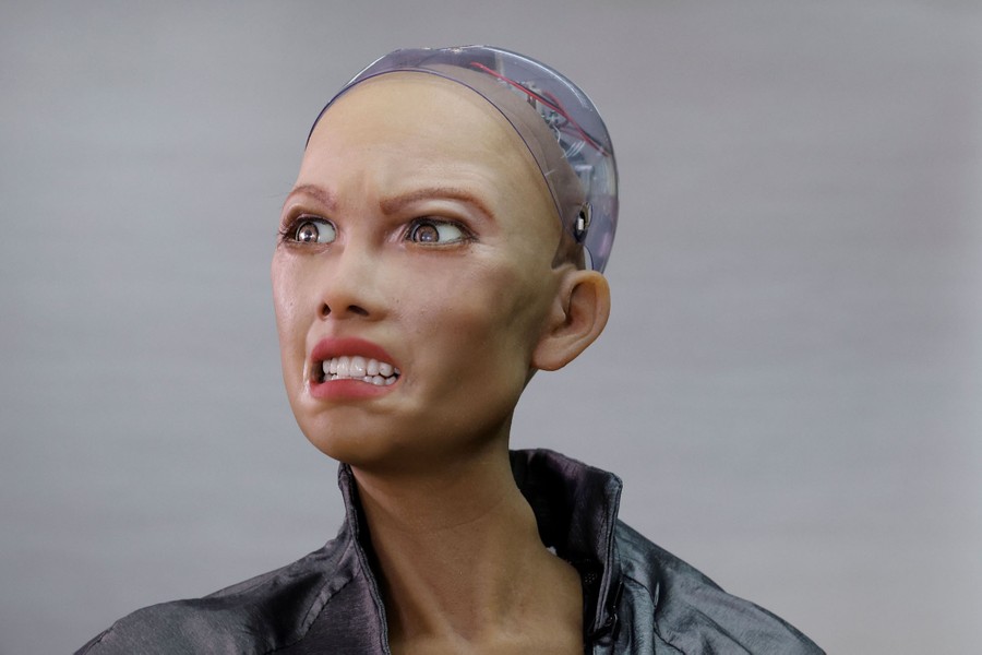 A human-like robot makes a strange facial expression.