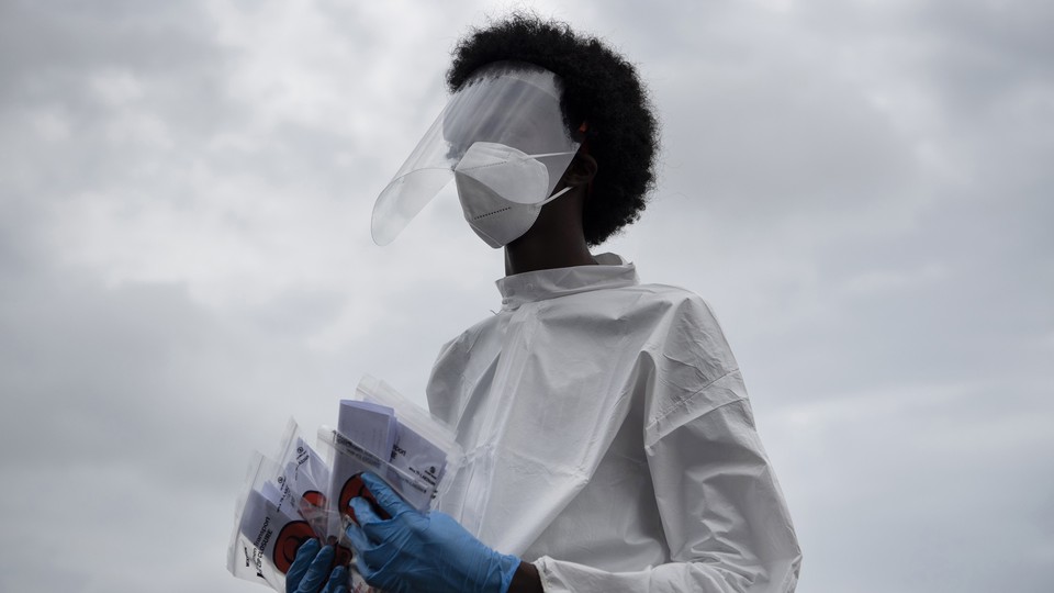 A health-care worker holding coronavirus tests
