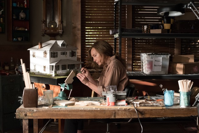 film still of the mother, Annie Graham, from "Hereditary" at work in her artist's studio