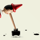 A long-nosed Pinocchio figure dipping his nose in a pot of ink