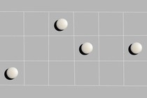 Illustration of a grid on which four white pills rest