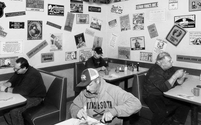 A diner full of people eating alone