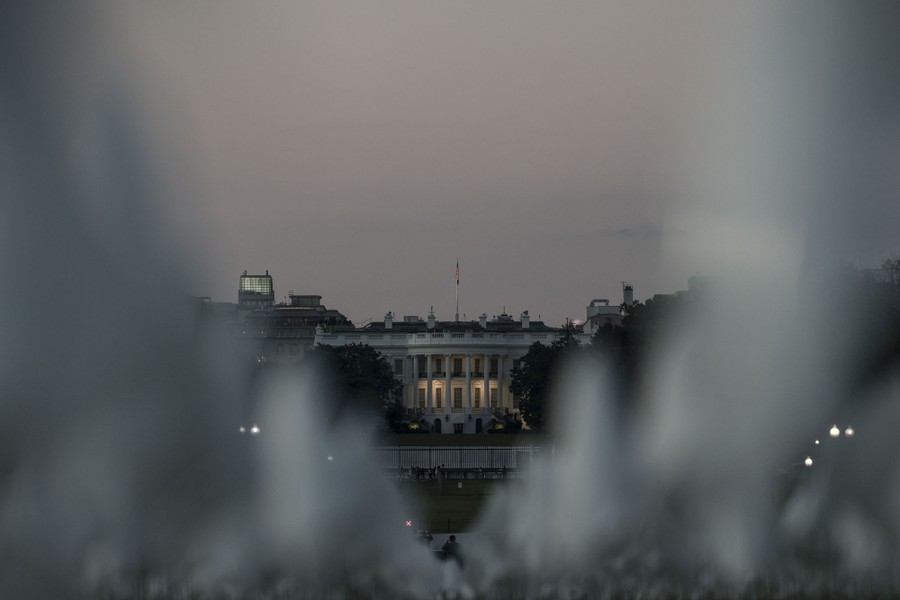 The White House is seen through flags of the installation.