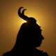 Silhouette of a person wearing horns