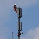 A worker atop a mobile-phone tower
