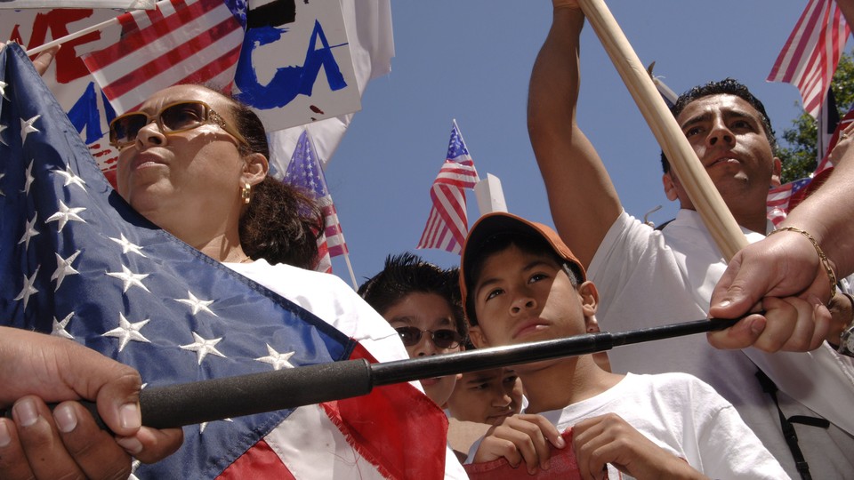 A photo of Latinos demonstrating with American flags