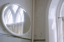 A photograph of a mirror in a bathroom
