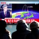 People watch a television broadcast of a news report on North Korea firing what appeared to be an intercontinental ballistic missile.