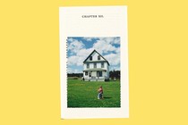A picture of a boy in front of a house on a page that says "Chapter XII."