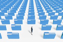 person looking back at rows and rows of file folders
