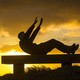 A man exercising on a bench