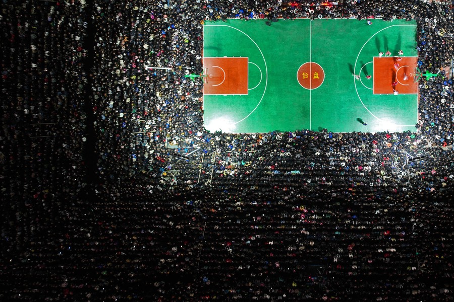An aerial view of a crowd watching a basketball game in China
