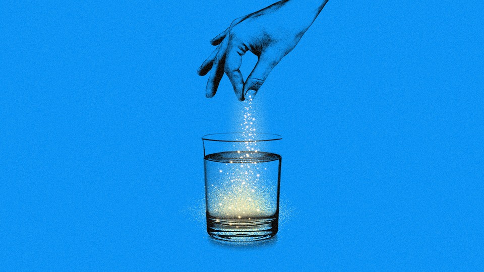 A hand sprinkling powder into a glass