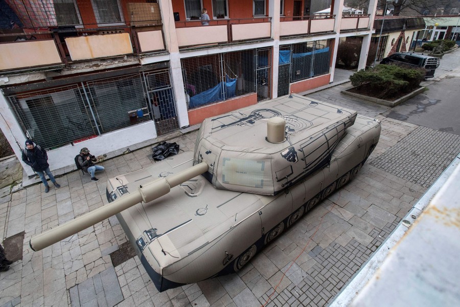 An inflatable replica of an M1 Abrams tank, in a courtyard
