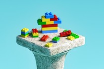 An old stone pillar with Lego blocks on top of it