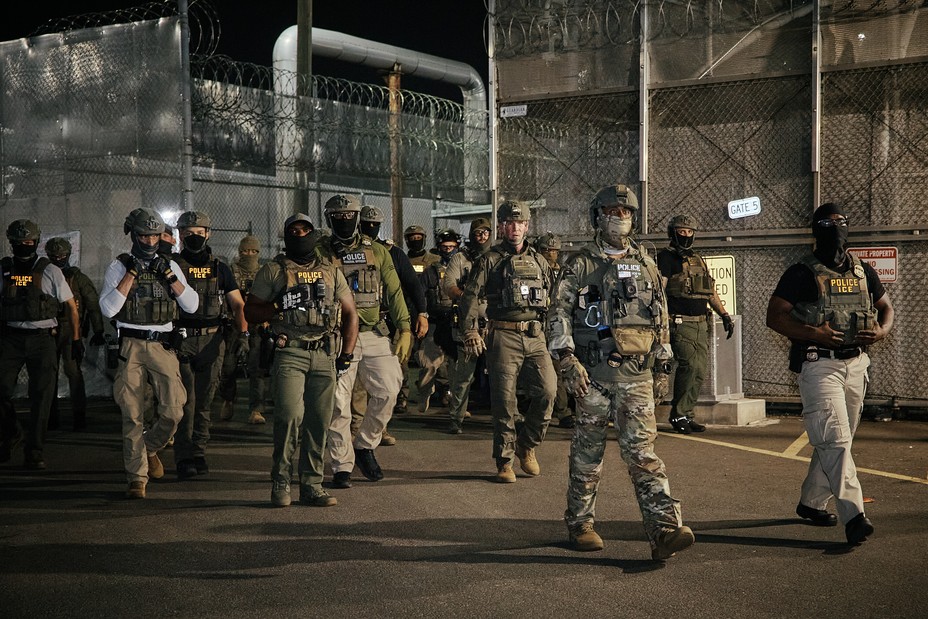 armed police men walk forward as a group