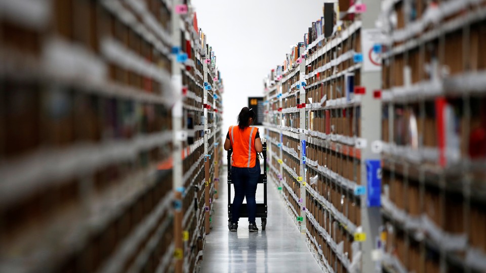 Employee looks for items in an Amazon warehouse