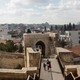 Two boys walk along a stone wall in Istanbul, Turkey