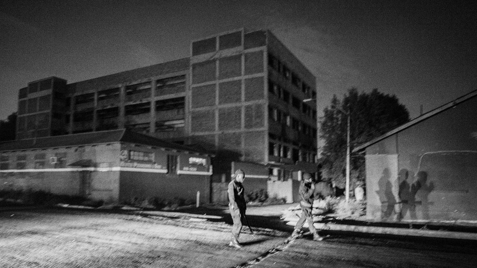 A black-and-white photo of South African police officers patrolling Johannesburg
