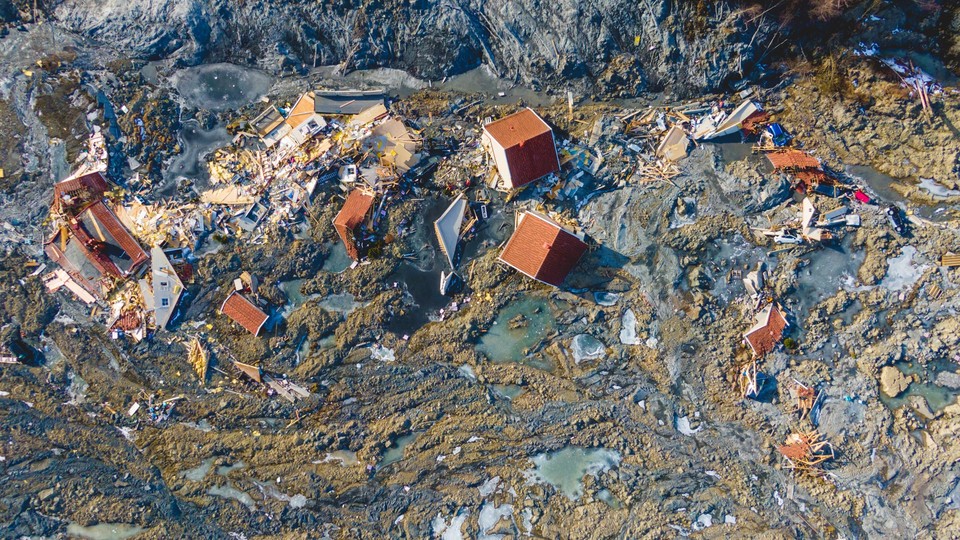 Houses torn from their foundations by a landslide
