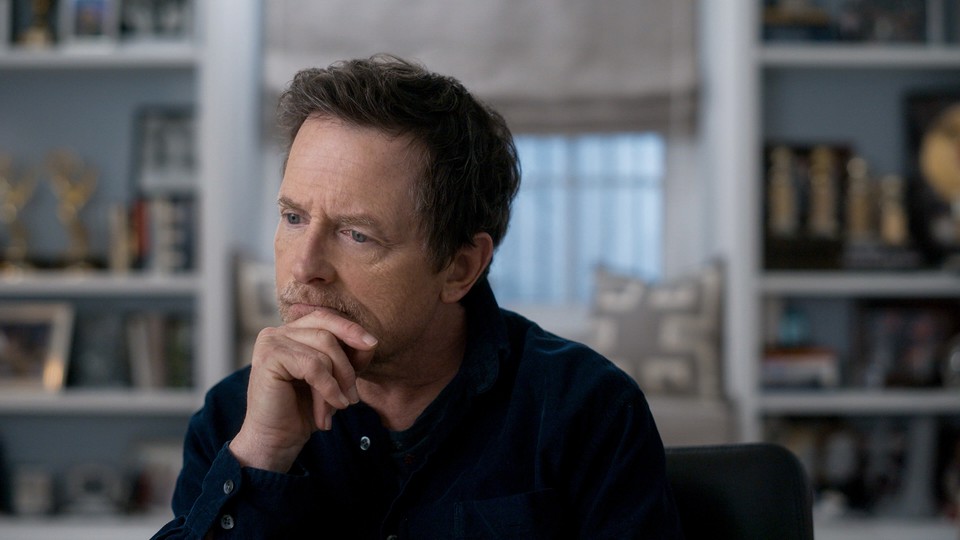 A screenshot of "Still: A Michael J. Fox Movie" showing the star looking pensive