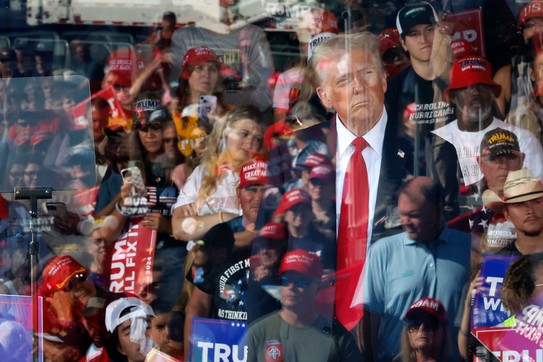 Photograph of Donald Trump looking at his supporters at a rally