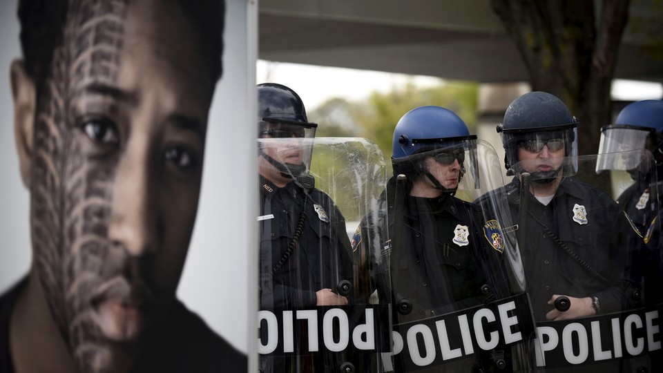 Baltimore police form a line during clashes with protesters after Freddie Gray's funeral in 2015.