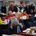Republican candidate Donald Trump looks at a newspaper 