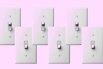 A row of light switches in on and off positions