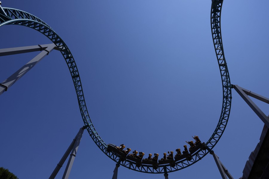 Visitors enjoy a ride on a roller coaster.
