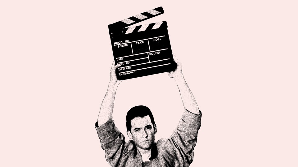 A photo of John Cusack holding a clapperboard above his head