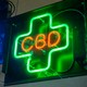 A green-and-red neon sign for CBD
