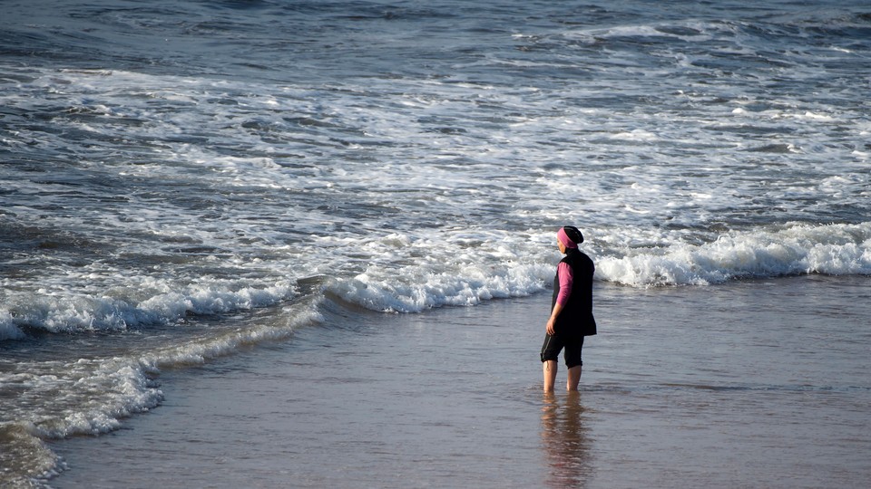 A women wearing a burqini at the beach.
