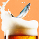 A salmon jumping out of a glass of beer