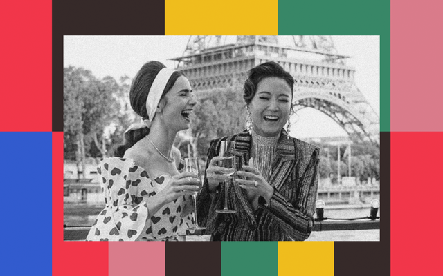 Lily Collins as Emily Cooper in "Emily in Paris" laughs with a friend while drinking champagne in front of the Eiffel Tower.