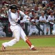 A professional baseball player hits a ball with his bat during the ninth inning. 