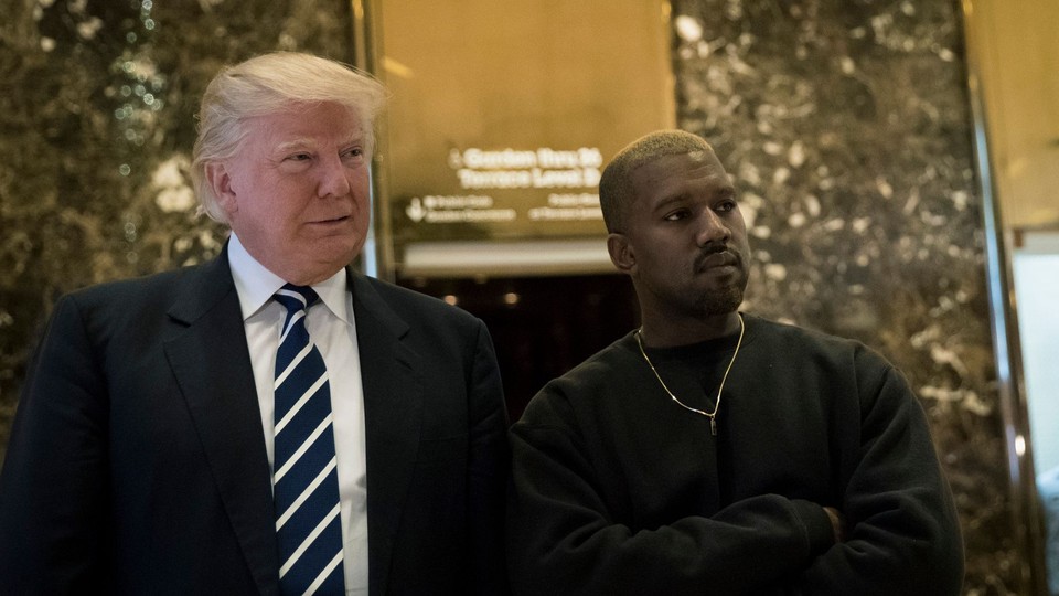 Donald Trump and Kanye West stand together in the lobby at Trump Tower, December 13, 2016 in New York City.