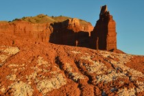 An orange rock formation on sunny day