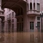 Floodwater covers the courtyard of a building.