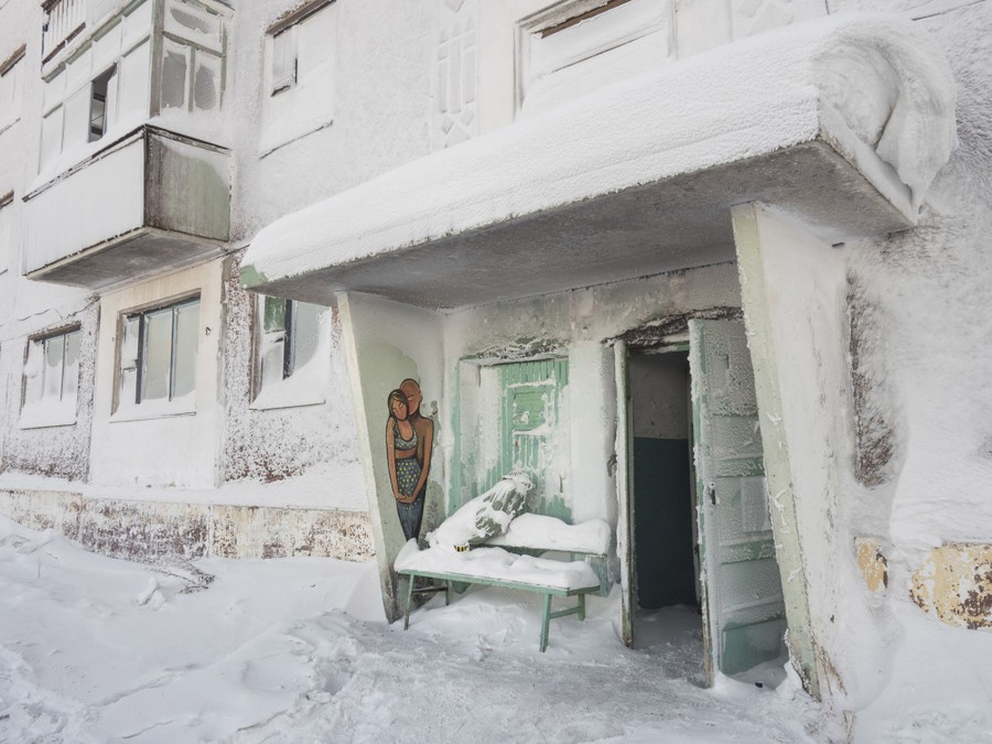 The entryway to a snow- and ice-covered building