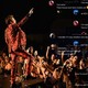 A photo of Harry Styles performing in concert, overlaid with screenshots from a Discord channel.