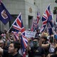 Pro-democracy protesters wave flags outside of the UK Embassy in Hong Kong in September 2019.