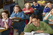 A historical photo of students sitting in a classroom