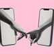 An image of two arms coming out of two phone screens, holding hands
