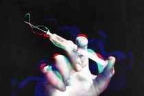 Treated photograph of a hand holding a syringe