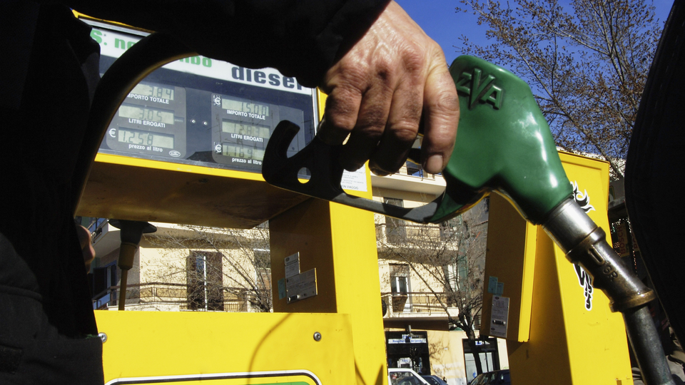 An image of a person holding a gas pump.