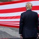 U.S. President Donald Trump stands in front of the American flag.