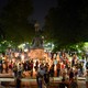 Charlottesville community members are seen leaving candles at the base of a statue of Thomas Jefferson.