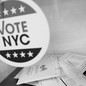A black-and-white photograph of ballots and a Vote NYC sticker